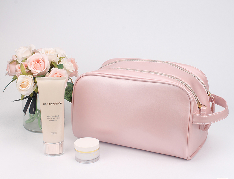Large capacity pink satin cosmetic bag with side small hand strap, single metal zipper, portable skincare toiletry organizer bag